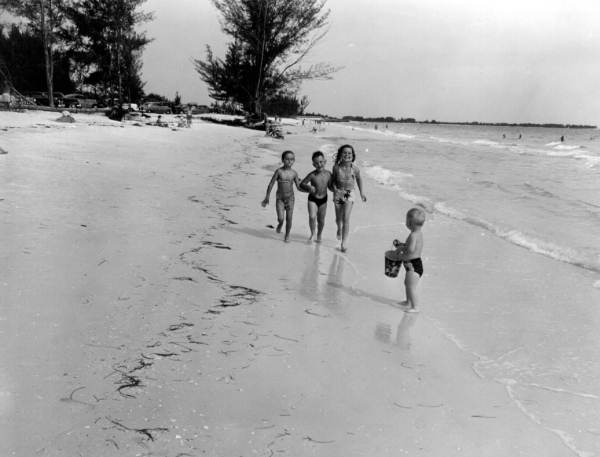 Children frolic on the beach.