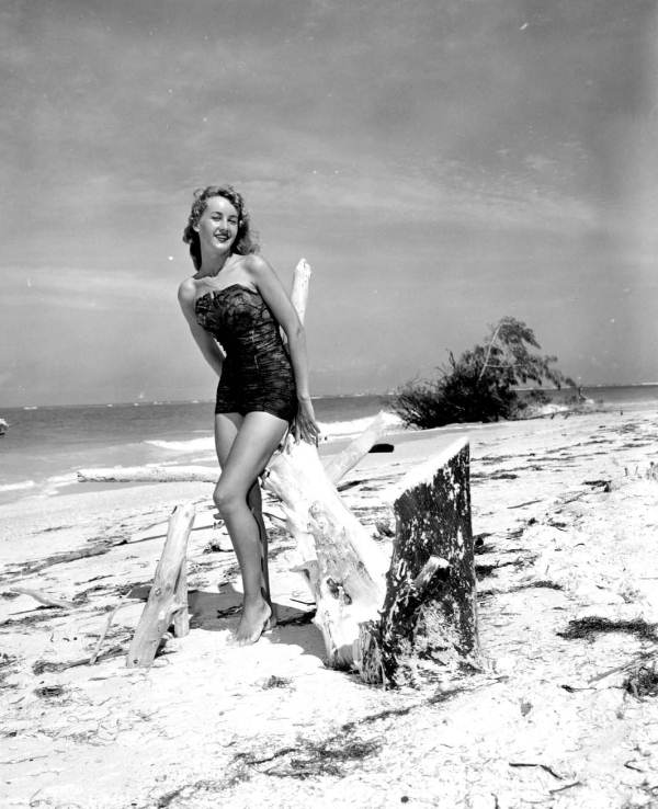 Pat Sexauer posing with pieces of driftwood - Lido Beach, Florida.