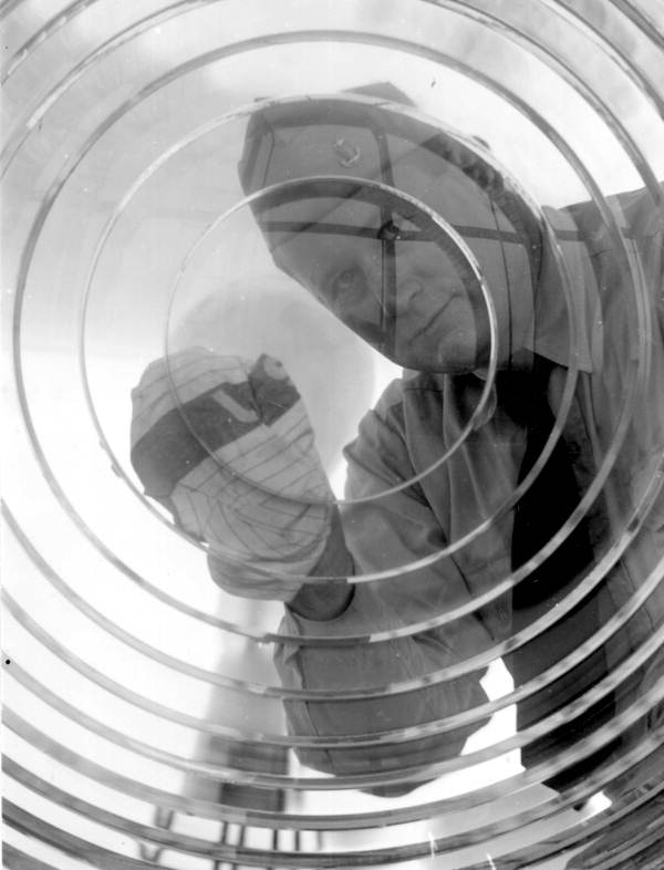 Lighthouse keeper cleaning lens at the Pensacola Lighthouse - Escambia County, Florida.