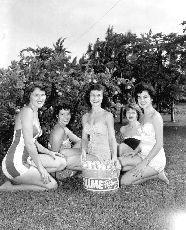 Young women pose for photographs during the Key Lime Festival - Key Largo, Florida