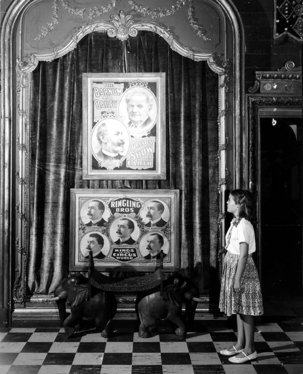 Child looking at poster portraits of Ringling Brothers and Barnum and Bailey- Sarasota, Florida.