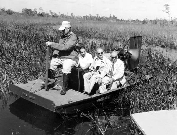 Arthur Cobb, Ricardo Estrada-Berg and A. Clifton Johnson of the Inter-American Tourism Conference on airboat tour