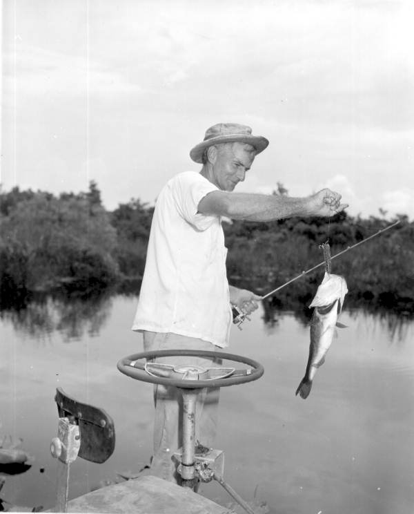 Man displaying his catch from the Everglades.