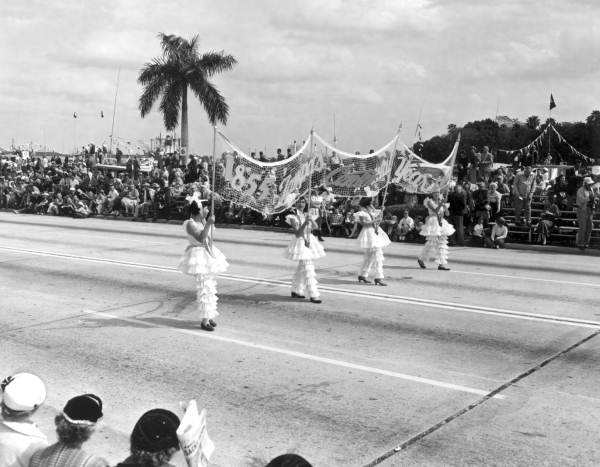 Young girls carrying a banner in the Gasparilla festival parade - Tampa, Florida.