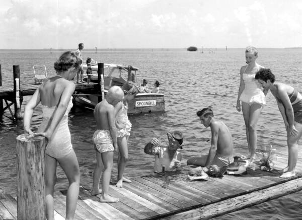 Herb Alley dives for Florida lobster and shells for the amusement of his guests - Tavernier, Florida.