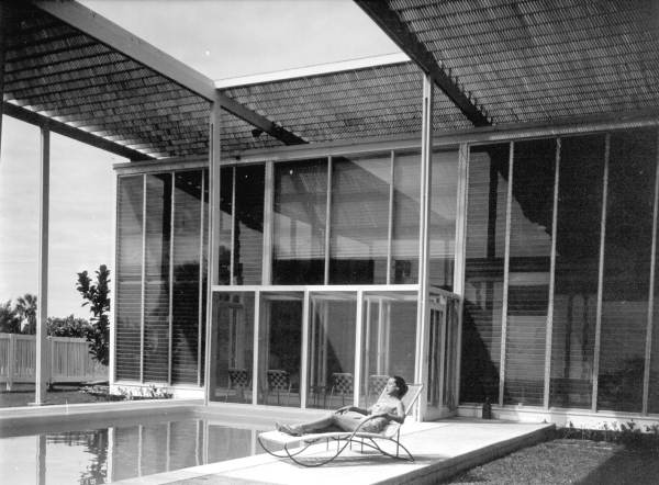 Woman sunbathing on the patio at the Sommers "slat" home - Sarasota, Florida