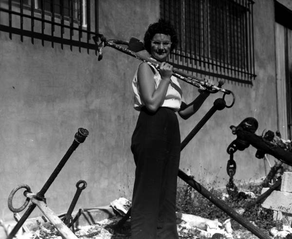 A woman carries an old anchor outside the McKee's Museum of Sunken Treasure - Plantation Key, Florida