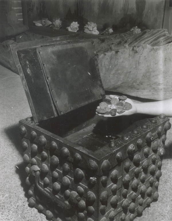 A handful of silver coins and a treasure chest displayed at McKee's Museum of Sunken Treasure - Plantation Key, Florida