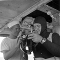 Unidentified man assists Art McKee put on his diving equipment - Plantation Key, Florida .