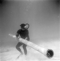 Divers holds on to pipe at Capitana wreck site - Plantation Key, Florida .