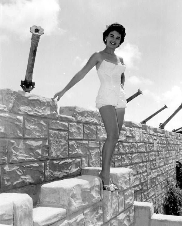 Jackie Sweeting poses on the wall of the McKee's Museum of Sunken Treasure - Plantation Key, Florida