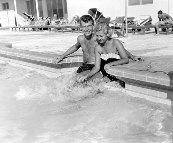 Couple enjoying the pool at the Desert Ranch motel - Saint Petersburg Beach, Florida.