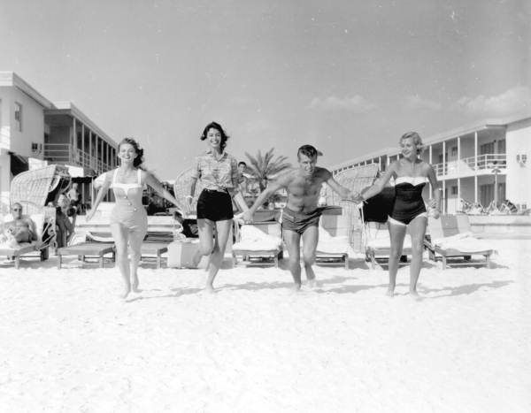 People running on the beach by the Desert Ranch motel.