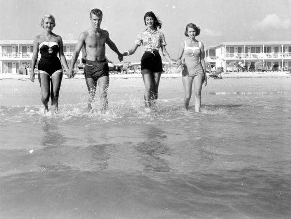 People enjoying the water by the Desert Ranch motel - Saint Petersburg Beach, Florida.