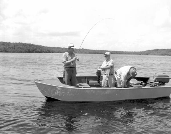 Carl Hansen, Benny Whitehead and Everett Williams inspect a freshly caught grouper - Everglades, Florida.