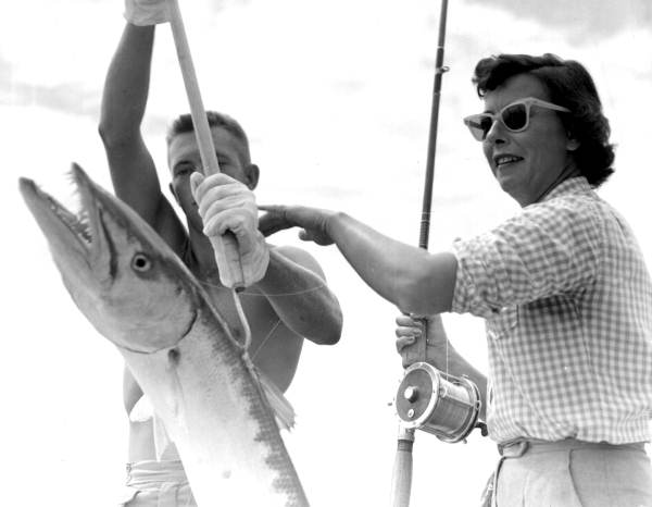 Ruth Martenhoff and Brian Eakin unhook a barracuda - Florida Keys, Florida