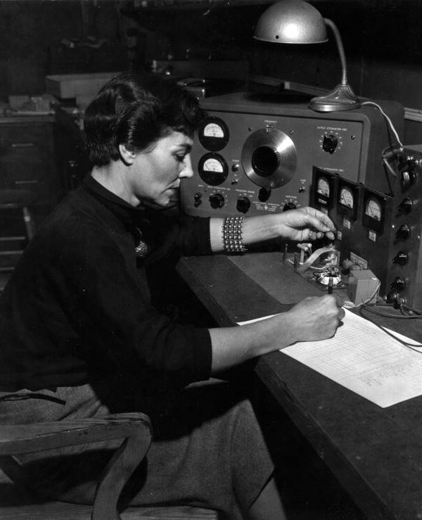 Mrs. Clementine Fowler recording data from lab test of filter component..