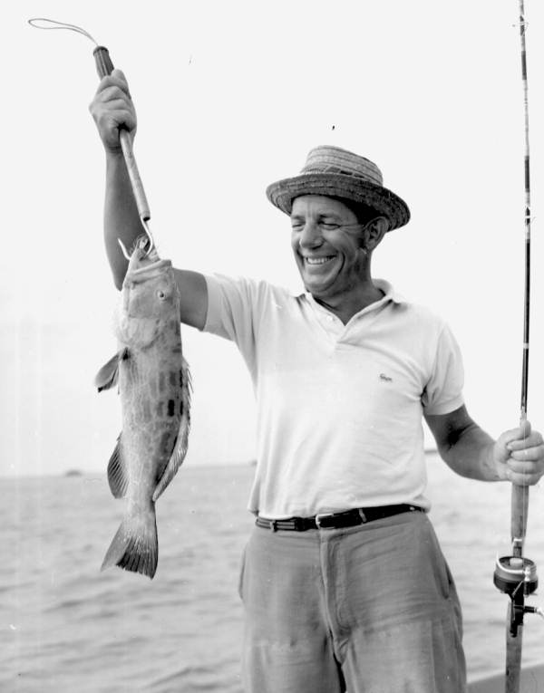 Fisherman proudly displaying his nassau grouper catch - Marquesas Keys, Florida