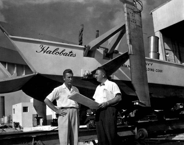 Two engineers discussing in front of the boat "Halobates" built by Miami Shipbuilding Corporation - Miami Florida.