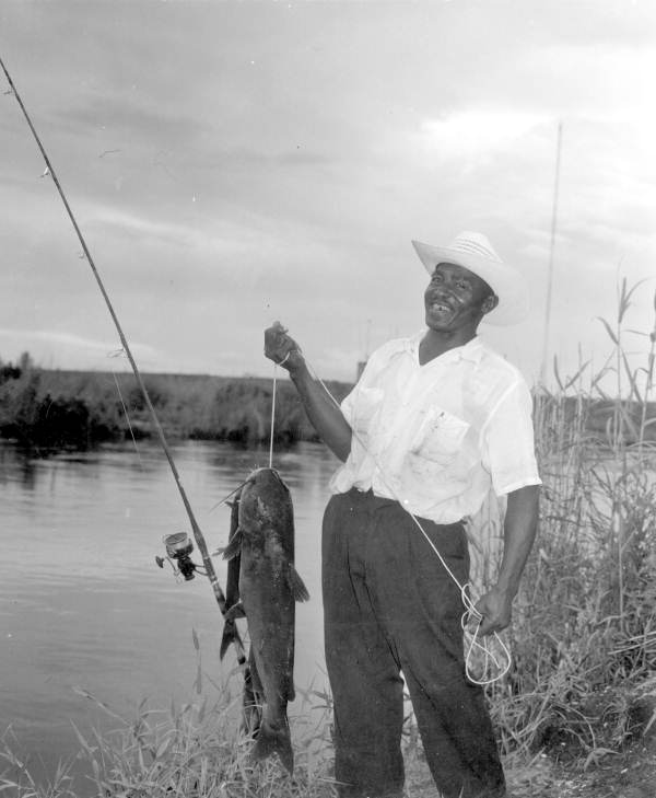African American man proudly displaying his catfish catch - Broward County, Florida