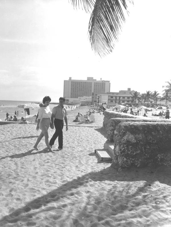 Couple walks on the beach - Miami, Florida.
