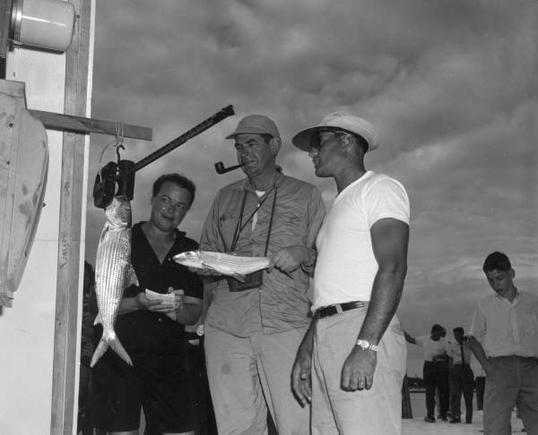 Three people weighing bonefish caught during the World Series of Sport Fishing - Marathon, Florida