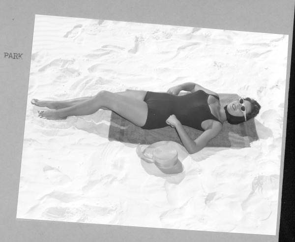 Kathy Magda models a bathing suit on the sand of Saint Andrews State Park