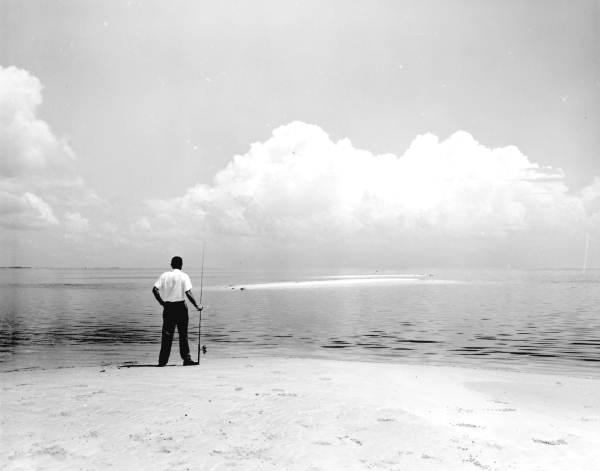 A fisherman standing on the beach at Live Oak Island - Wakulla County, Florida