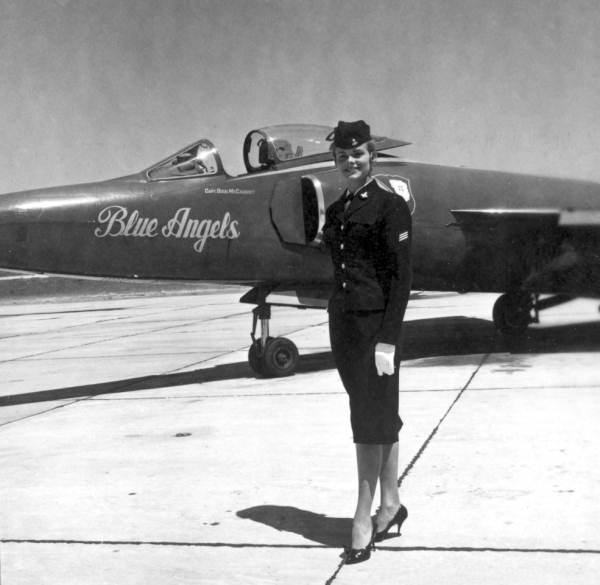 Joan Simmons poses next to a Blue Angels airplane during the anniversary of a naval air station - Pensacola, Florida.