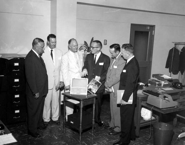 Roger Stake explains photo system to industrialists in the office - Tallahassee, Florida.