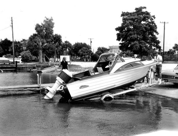 Family loading boat into water for excursion from Apalachicola to Pensacola.