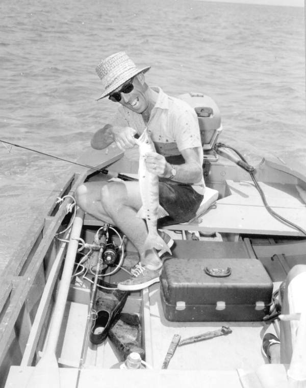 Fisherman unhooks his freshly caught barracuda - Florida Keys, Florida