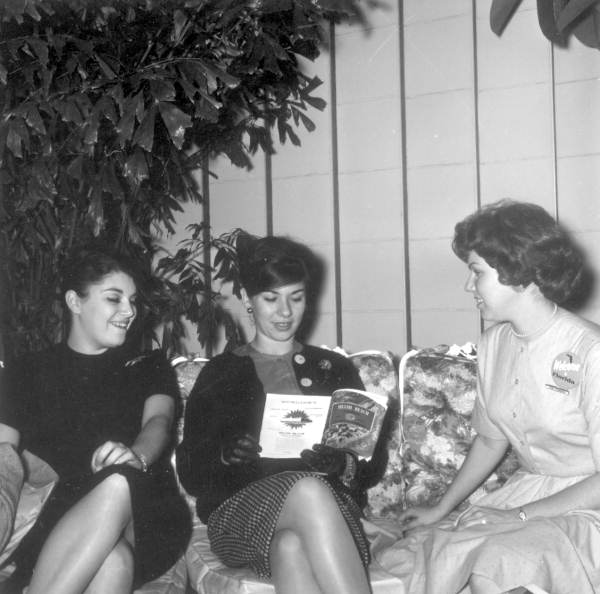 Visitors look at pamphlets at the showcase .,