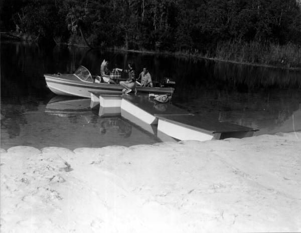 Pier boats used as a pier for a motorboat - Weeki Wachee Spring, Florida.