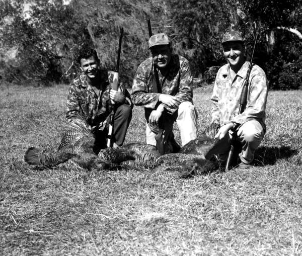 Three hunters happily pose with their catch of turkeys - Palmdale, Florida