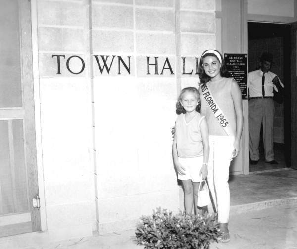 Miss Florida, Carol Blum, with a little friend at town hall - Saint Marks, Florida.