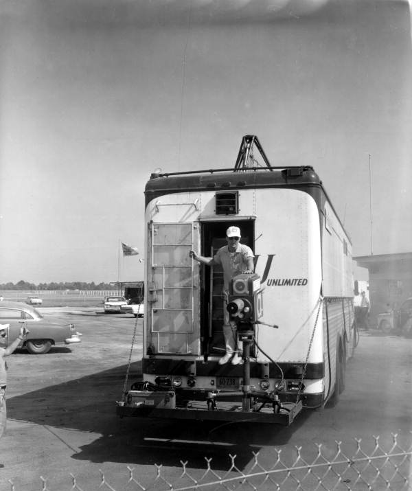 Cameraman and camera on the back of a bus - Daytona Beach, Florida