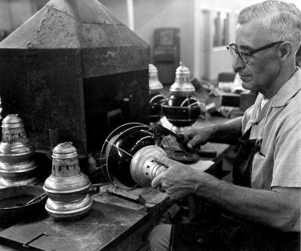 View of employee working at the Perkins Marine Lamp and Hardware Corporation in the Sunshine State Industrial Park - North Miami, Florida.