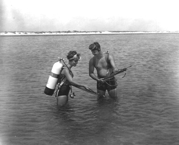 Man and woman prepare to go spear fishing - Pensacola, Florida.