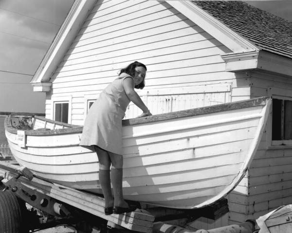 Zoe Ellen Parker poses with a surfboat displayed outside the House of Refuge Museum - Stuart, Florida.