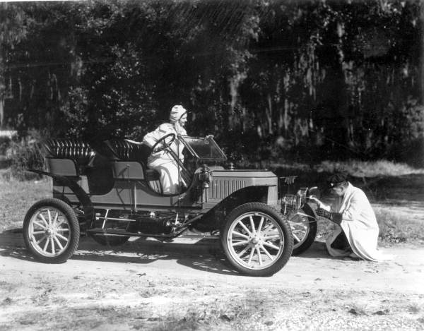 Couple inspecting antique automobile - Silver Springs, Florida