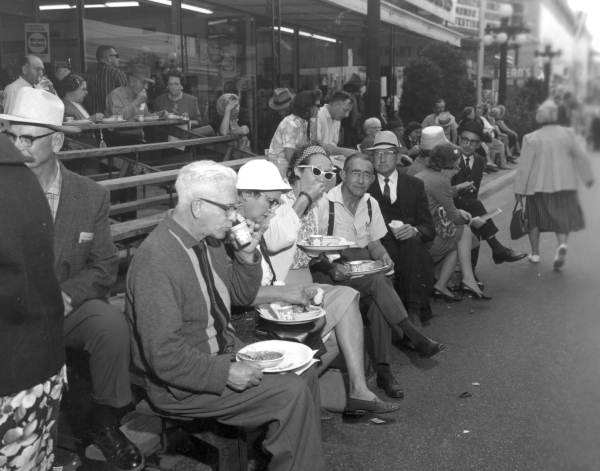 Several people eating bean soup during the Gasparilla Carnival - Tampa, Florida.