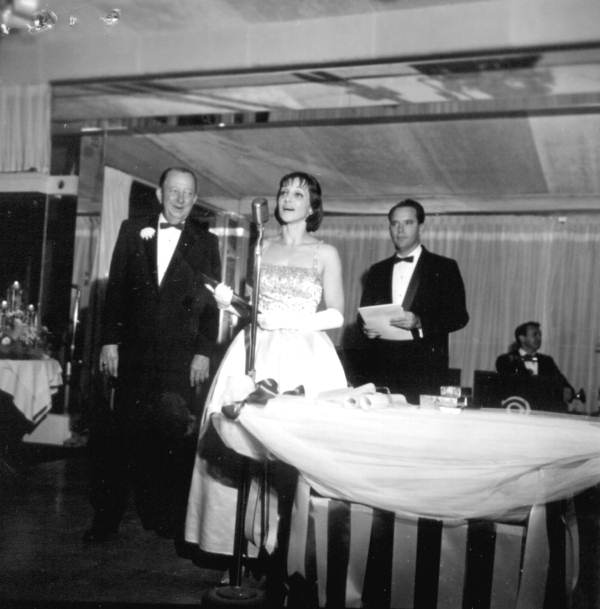 Woman singing at an arts festival dinner