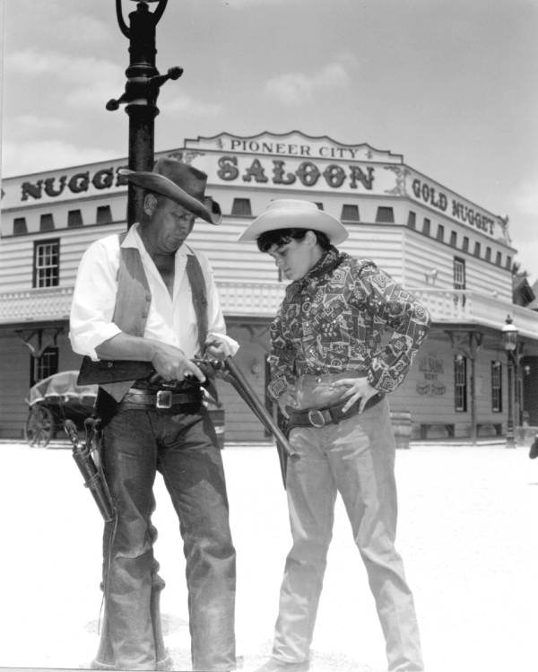 Cowboy reenactor with young visitor at Pioneer City - Davie, Florida.