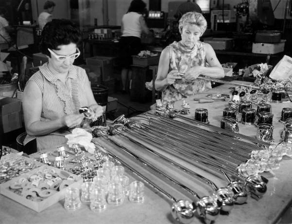 Unidentified women assemble lights for small boats - Miami, Florida