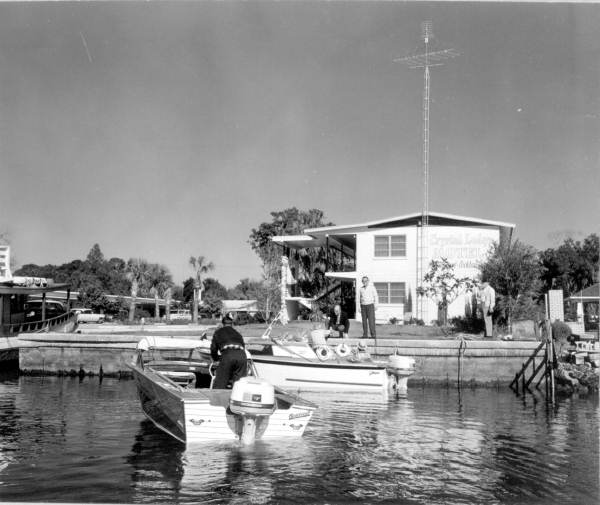 Boaters interact with people on shore - Crystal River, Florida