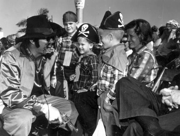 Two costumed boys being entertained at the Gasparilla parade - Tampa, Florida.