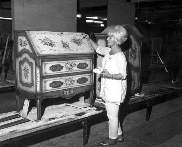 Unidentified employee paints a chest - Jacksonville, Florida .