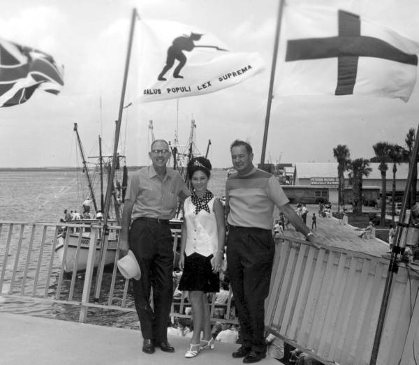 Two men and a woman pose for a picture near the docks - Pensacola, Florida.