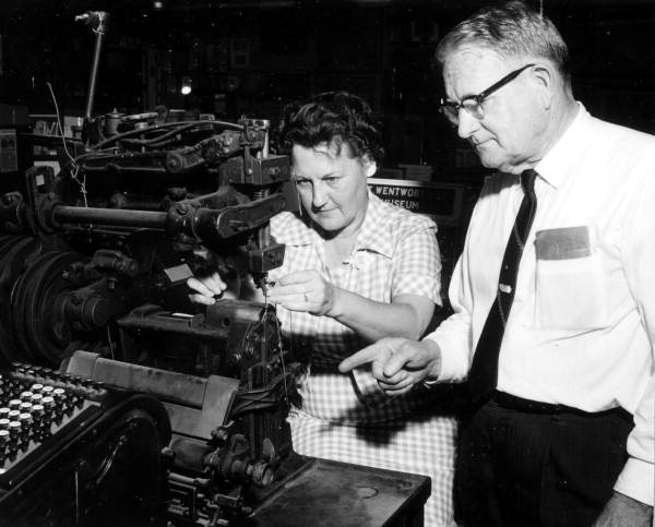 T.T. Wentworth Jr. and a museum staff member stand by a sewing device - Pensacola, Florida.